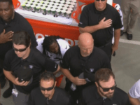 Nothing to See Here?: Raiders Staff Cover Marshawn Lynch As He Sits During the National Anthem