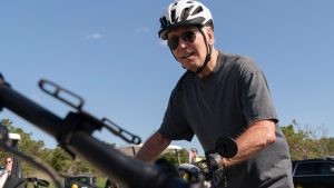 Biden falls off bike after stopping for crowd in Delaware